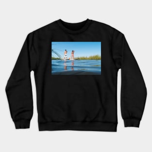 Man and woman stand up paddleboarding Crewneck Sweatshirt